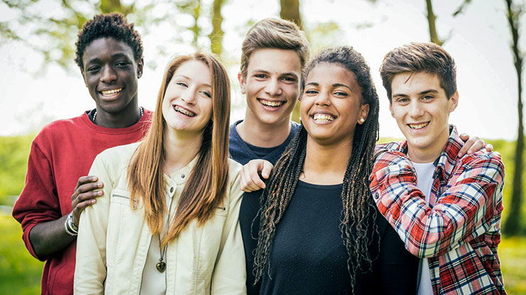 5 teenagers smiling facing forward 5 teenagers smiling facing forward